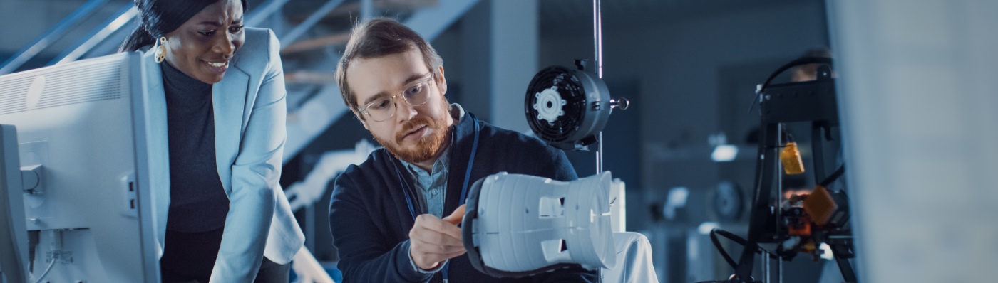 Two people looking at scientific equipment 